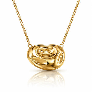 A polished yellow gold abstract pendant necklace with a textured, organic shape, suspended from a matching gold chain on a clean white background with a soft reflection below.