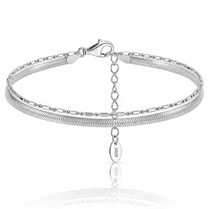A silver snake chain bangle bracelet with a lobster clasp, extender chain, and a dangling oval tag engraved with '925'.