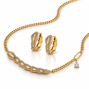 Gold jewelry set featuring a chain necklace with a geometric pavé-style front, matching huggie hoop earrings, and a small teardrop pendant, all set with clear stones on a white background.