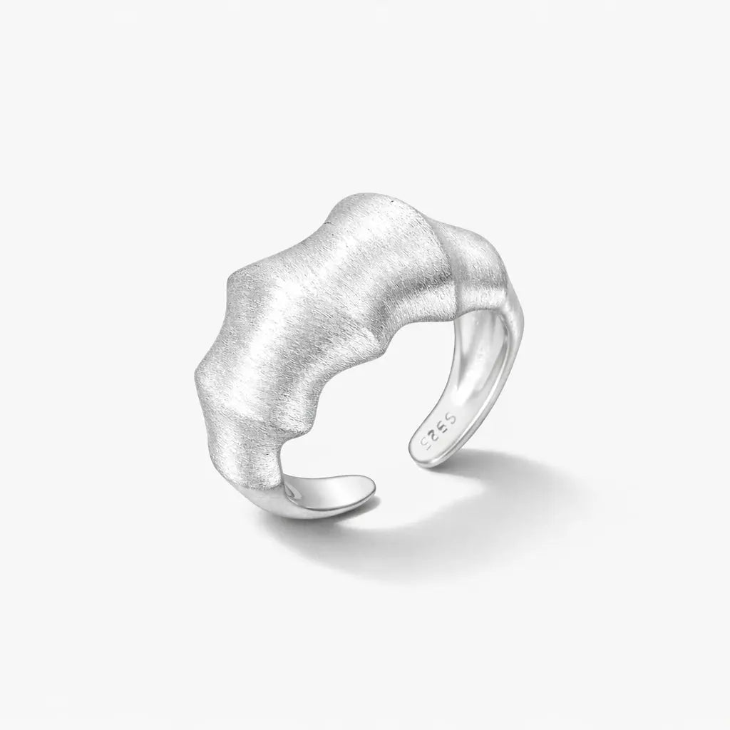 Textured open wave ring in 925 sterling silver on a plain white background