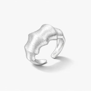 Textured open wave ring in 925 sterling silver on a plain white background