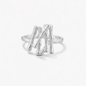 Textured silver branch ring with organic sculptural design on white background