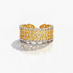 Gold and silver ring with diamond accents on a white background