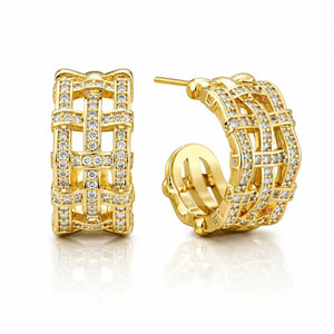 A pair of gold hoop earrings with a lattice-like openwork design, embellished with clear pavé stones, shown on a white background with a soft reflection.