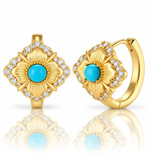 A pair of gold hoop earrings with a matching square flower-shaped front piece, featuring turquoise blue center stones surrounded by clear cubic zirconia accents, shown on a white background with a soft reflection.