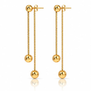 A pair of gold dangle earrings with spherical beads, shown on a clean white background with a subtle reflection below.