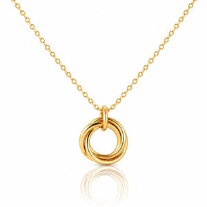 Gold necklace with a circular pendant on a white background