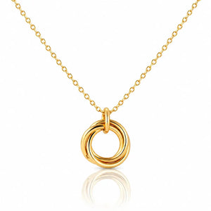 Gold necklace with a circular pendant on a white background