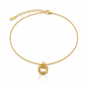 Gold bracelet with a small gold ring pendant on a white background