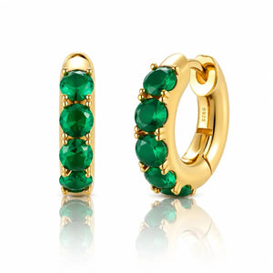 Gold hoop earrings with green gemstones on a white background