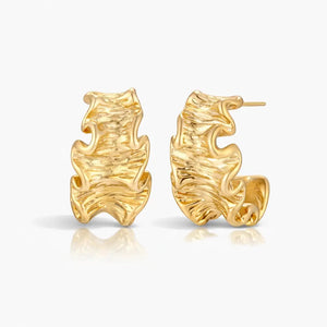 Pair of 18K gold plated textured wave hoop earrings on white background