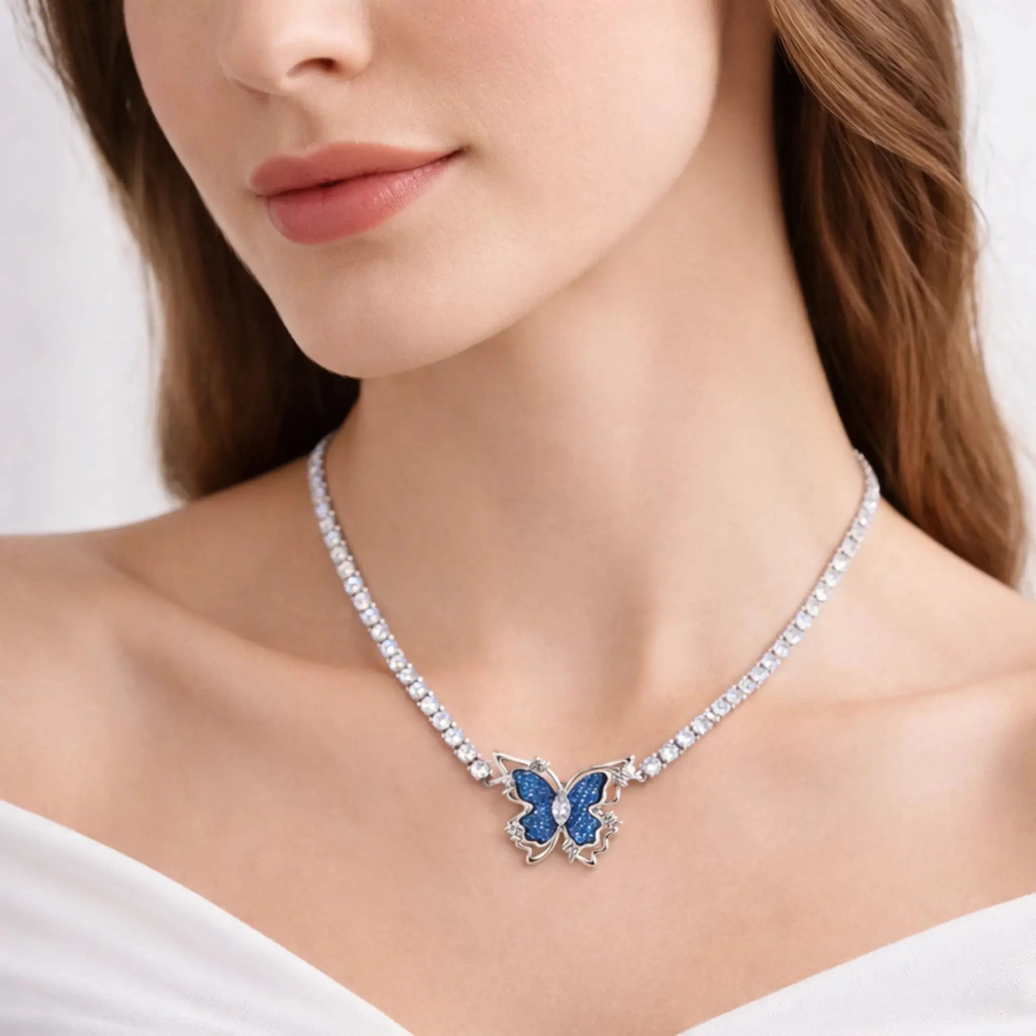 Woman wearing a sparkling butterfly necklace with blue gemstone pendant on a crystal chain