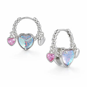 Pair of silver hoop earrings with heart-shaped gemstones on a white background