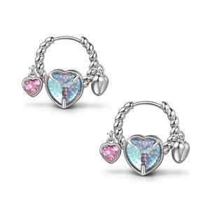 Pair of silver hoop earrings with heart-shaped charms on a white background