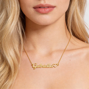 Model wearing personalized script heart name necklace in 18K gold finish