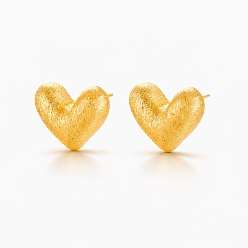 Pair of gold heart-shaped earrings on a white background