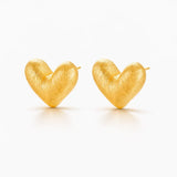 Pair of gold heart-shaped earrings on a white background