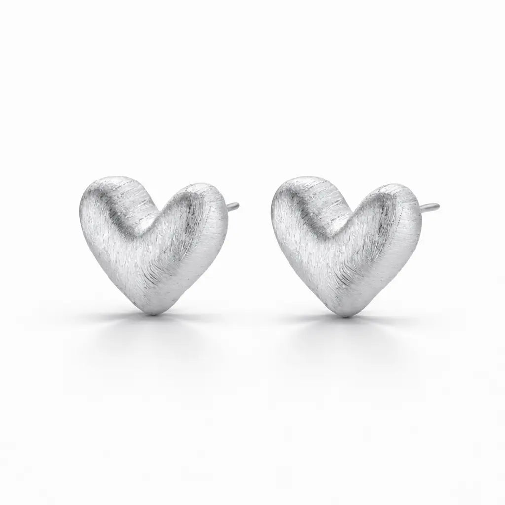 Heart-shaped silver earrings on a white background