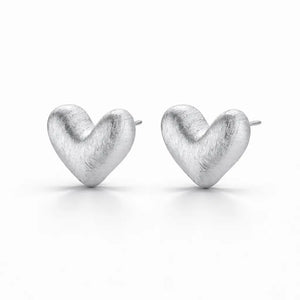 Heart-shaped silver earrings on a white background