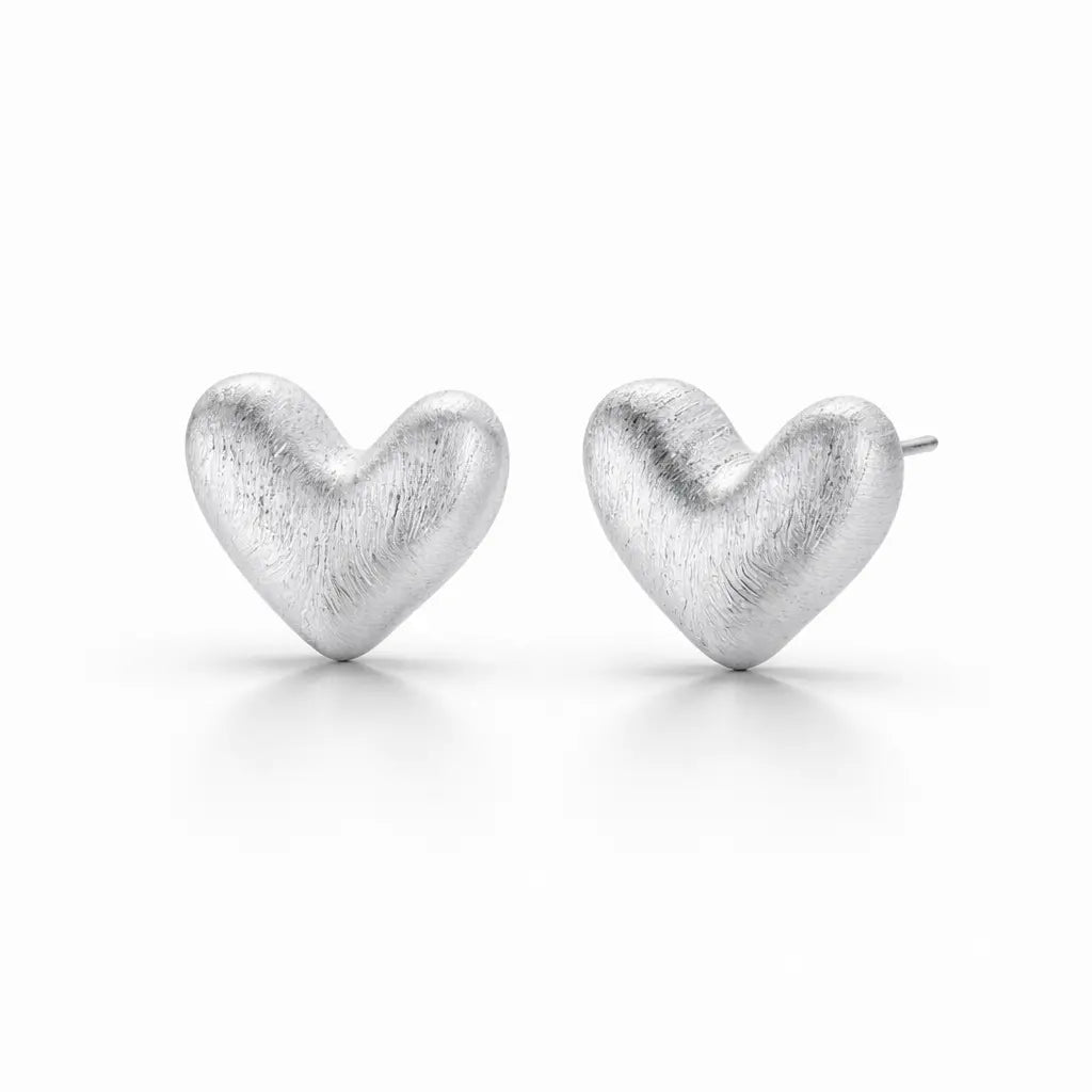 Pair of silver heart-shaped earrings on a white background