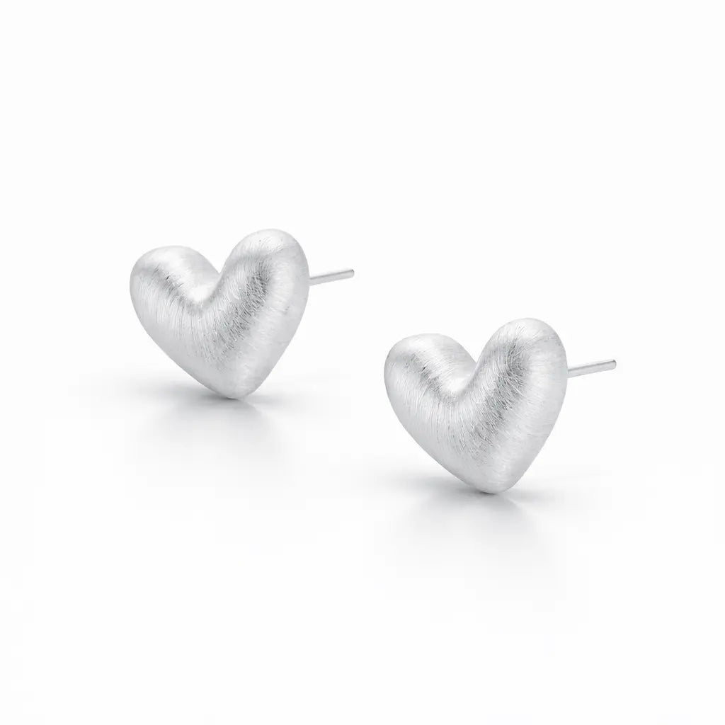 Heart-shaped silver earrings on a white background