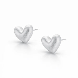 Heart-shaped silver earrings on a white background