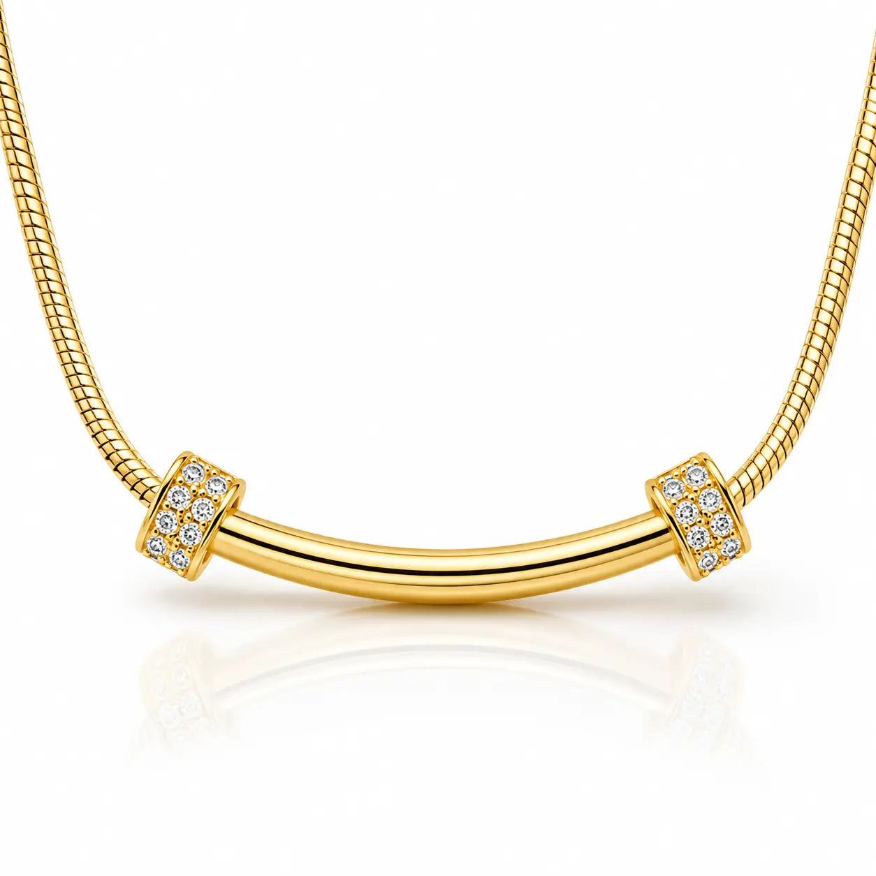 A gold snake chain necklace with a curved bar pendant, accented by square bezel-set clear crystals on each end, shown on a white background with a soft reflection.