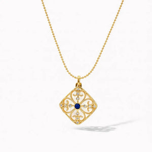 18K gold necklace with square medallion pendant, blue center stone, and intricate detailing