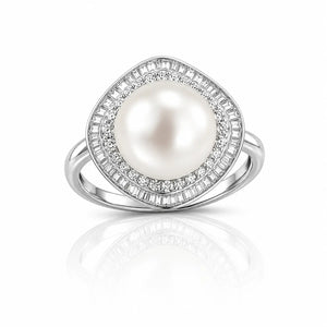 A silver-toned ring featuring a large oval white pearl surrounded by a double halo of small clear stones, set against a clean white background with a soft reflection below.