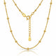 A gold beaded chain necklace with a matching extender chain and clasp, displayed on a clean white background with a subtle reflection.