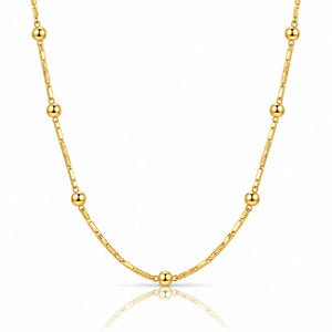 A delicate gold chain necklace featuring alternating small spherical beads and elongated oval links, displayed on a clean white background with a soft reflection below.