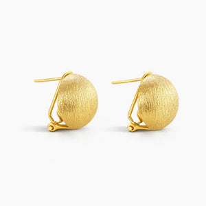 Pair of brushed 24K gold dome stud earrings with clip backs on white background