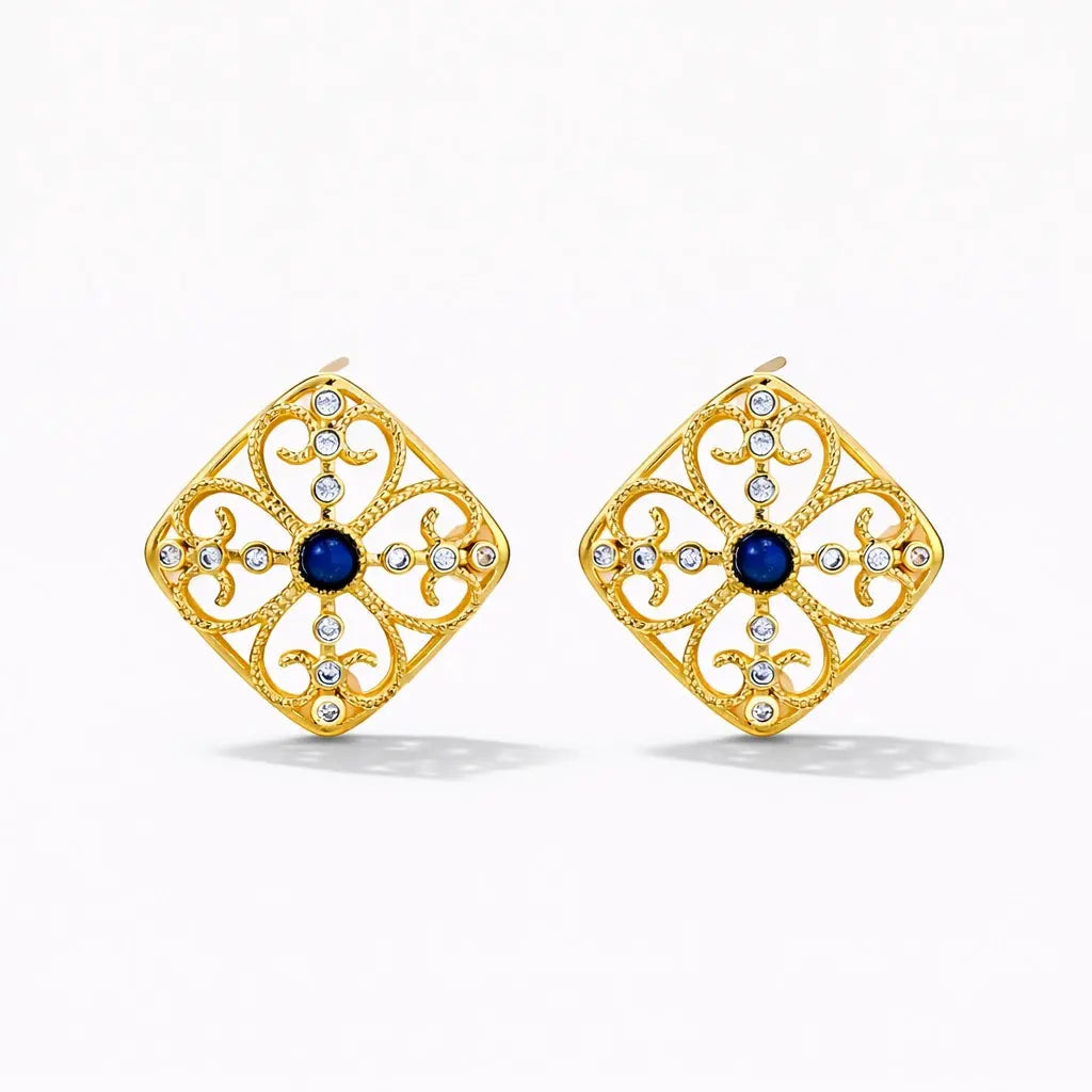Gold square stud earrings with blue center stone and crystal accents on white background