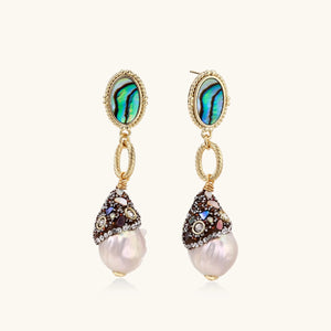 Pair of earrings with pearl drops and gemstone accents on a white background