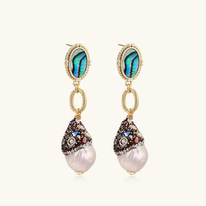 Pair of earrings with pearl drops and gemstone accents on a white background