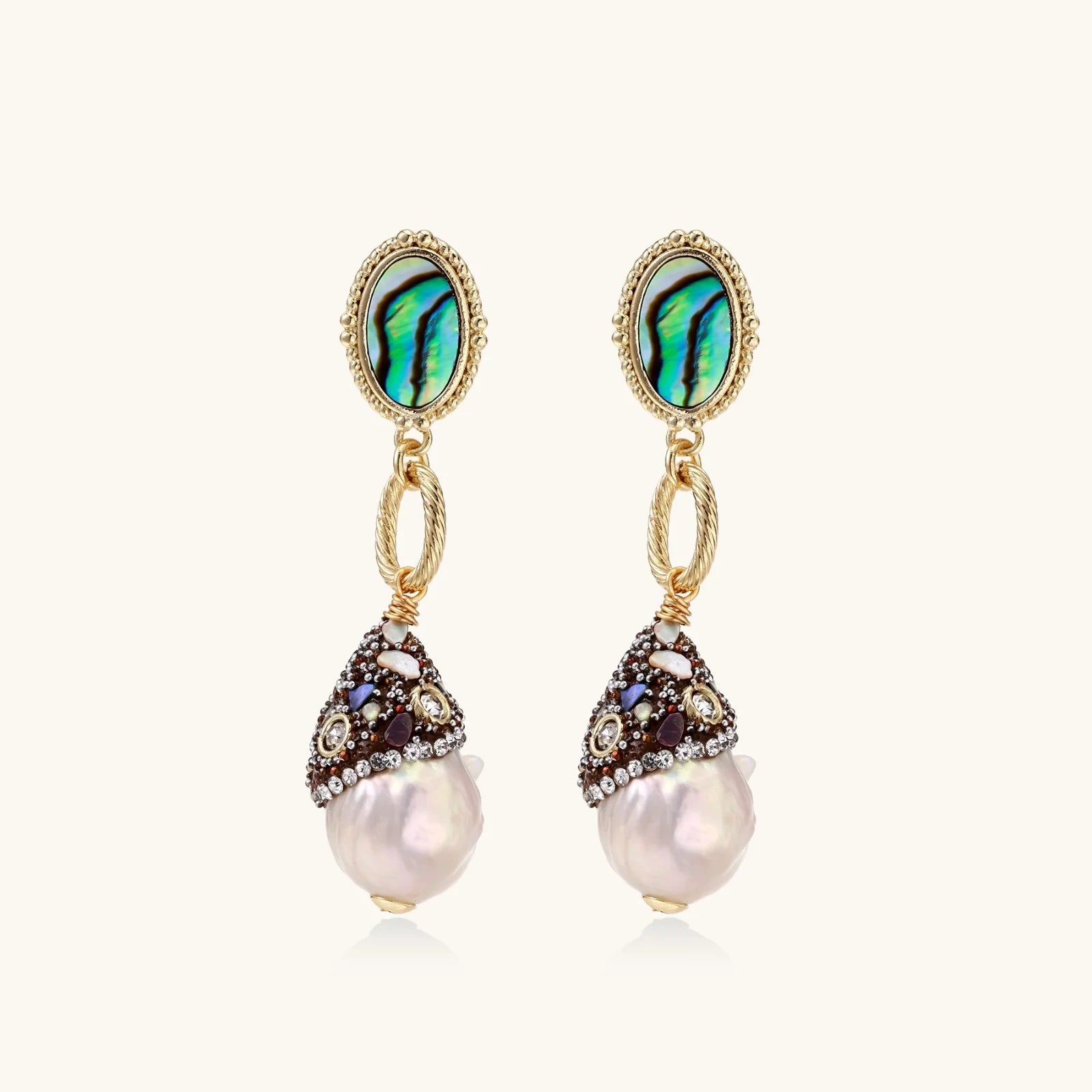 Pair of earrings with pearl drops and gemstone accents on a white background