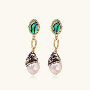 Pair of earrings with pearl drops and gemstone accents on a white background