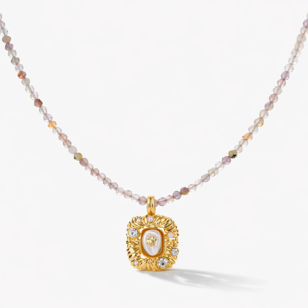 Necklace with a gold pendant and multicolored beads on a white background