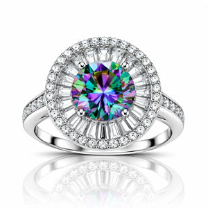 A radiant halo ring featuring a large round-cut iridescent center stone with a silver-toned pavé setting and a halo of clear baguette and round diamonds, shown on a white background with a reflection below.