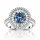 A radiant halo ring featuring a large round-cut iridescent center stone with a silver-toned pavé setting and a halo of clear baguette and round diamonds, shown on a white background with a reflection below.
