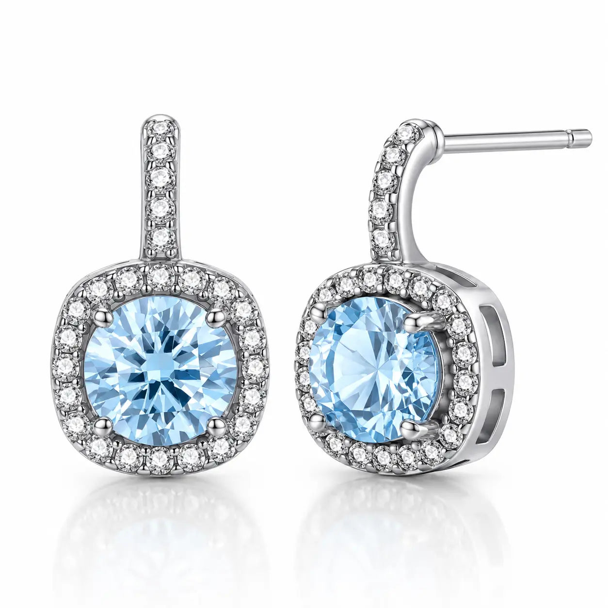 Pair of earrings with blue gemstones and silver accents on a white background
