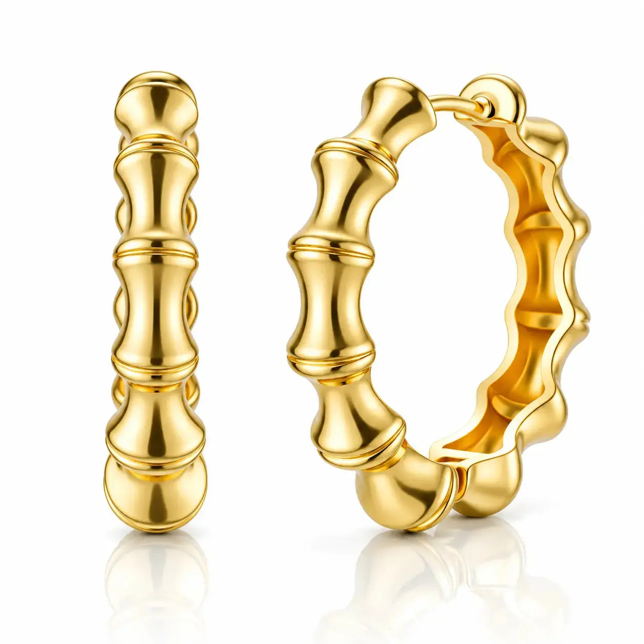 A pair of gold hoop earrings with a polished bamboo-inspired segmented design, shown on a clean white background with a soft reflection below.