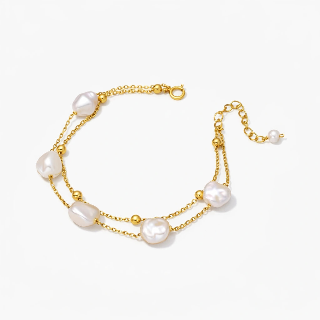 Gold bracelet with pearls on a white background