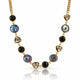A gold chain necklace featuring alternating round black onyx beads, faceted smoky quartz triangle beads, and irregular iridescent pearl beads in gold settings, displayed on a clean white background with a soft reflection.