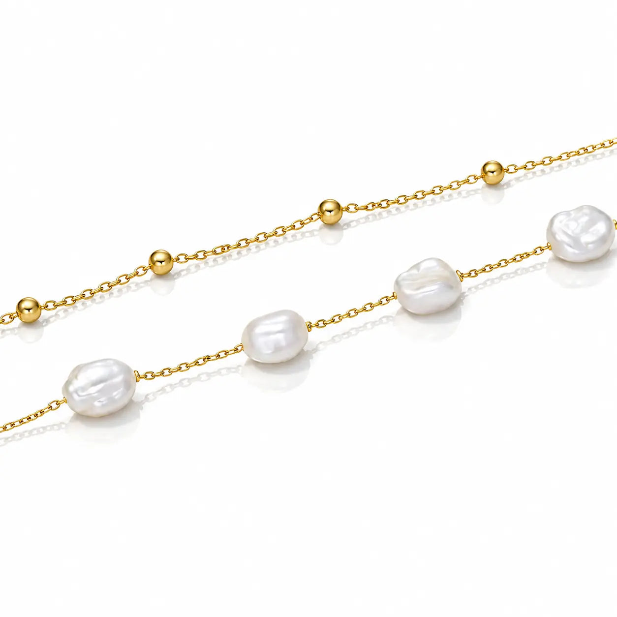 A delicate gold chain necklace featuring irregular white baroque pearls and small polished gold beads, displayed on a clean white background.