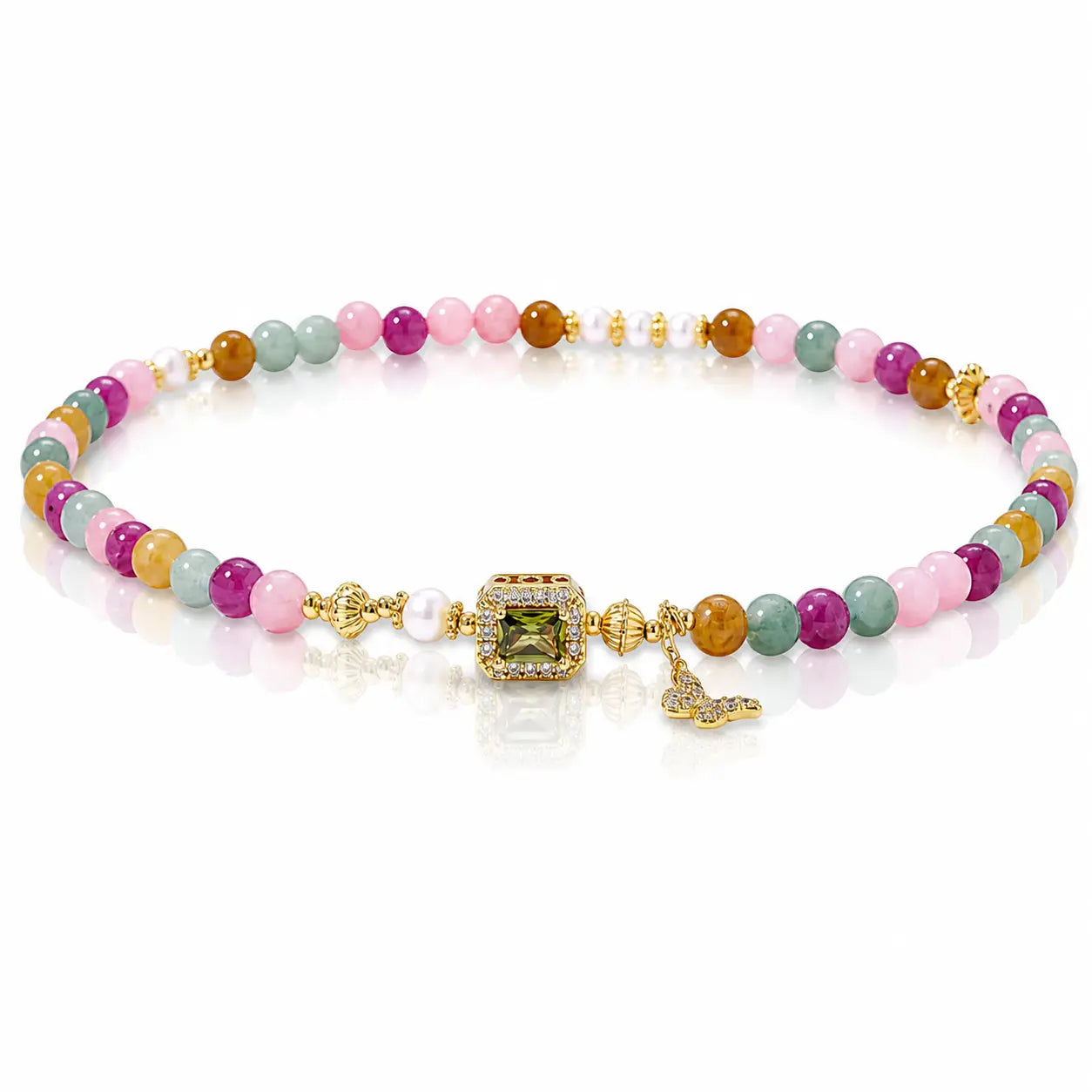 A multicolor beaded bracelet with gold-plated metal details, featuring a central green gemstone, a small white pearl, and a butterfly charm, displayed on a clean white background.