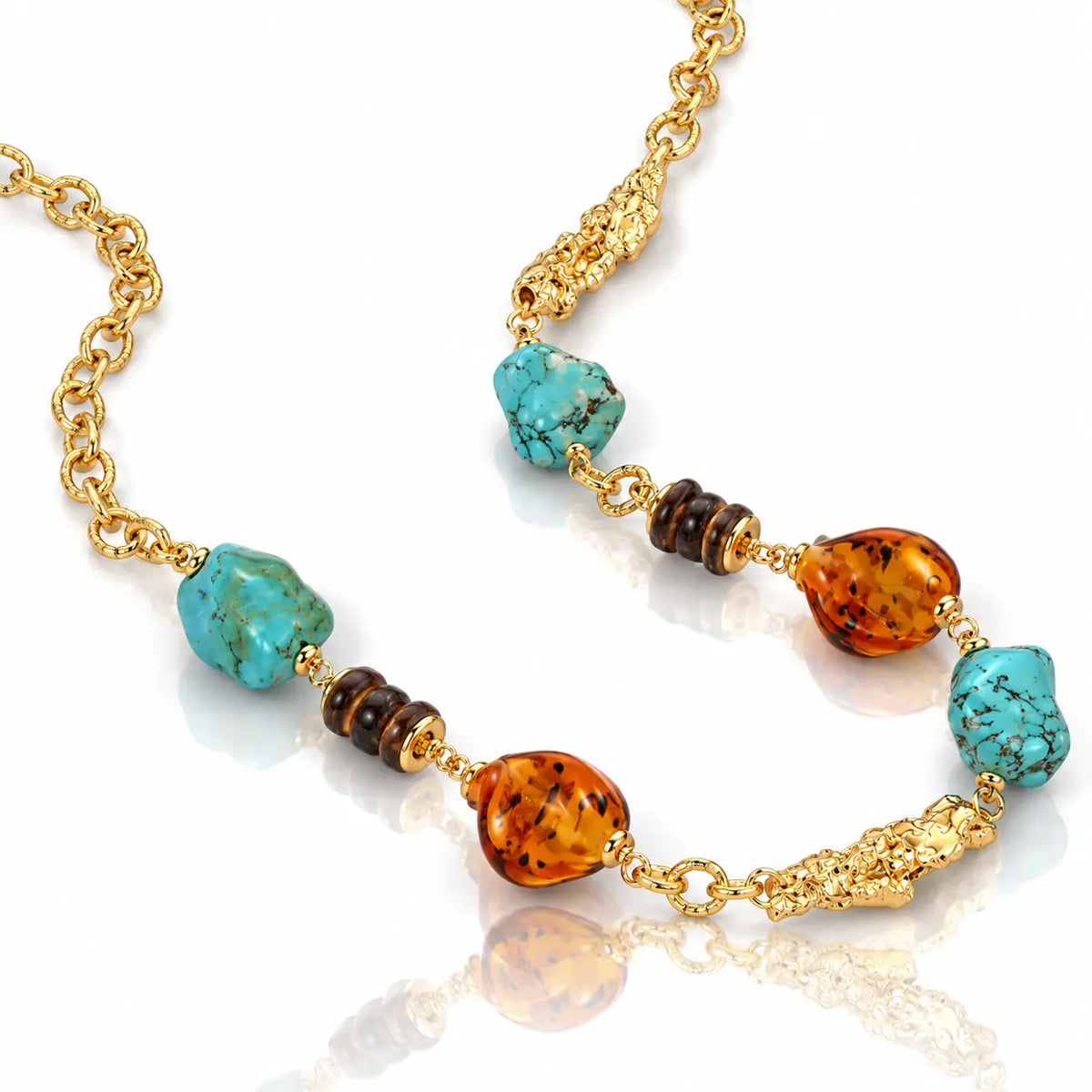 A gold chain necklace featuring turquoise, amber, and dark brown beads, displayed on a clean white background with a soft reflection.
