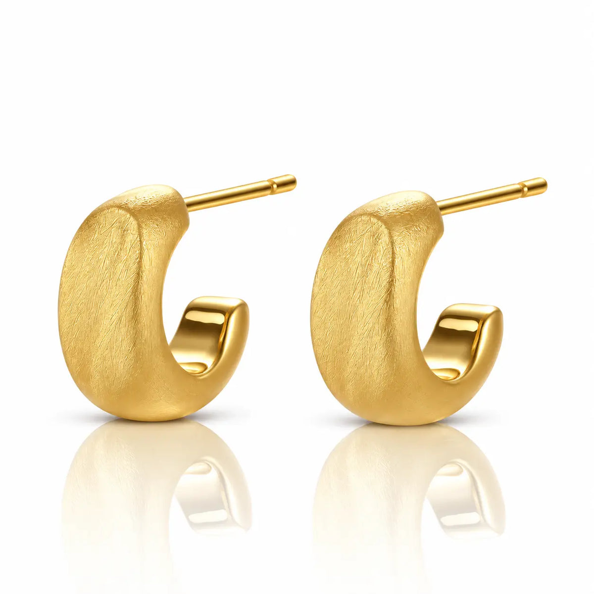 A pair of textured gold huggie hoop earrings with post backs, displayed on a clean white background with soft reflections below.