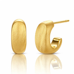 A pair of textured yellow gold hoop earrings, one shown from the front and the other from the side displaying the post, on a clean white background with a soft reflection below.