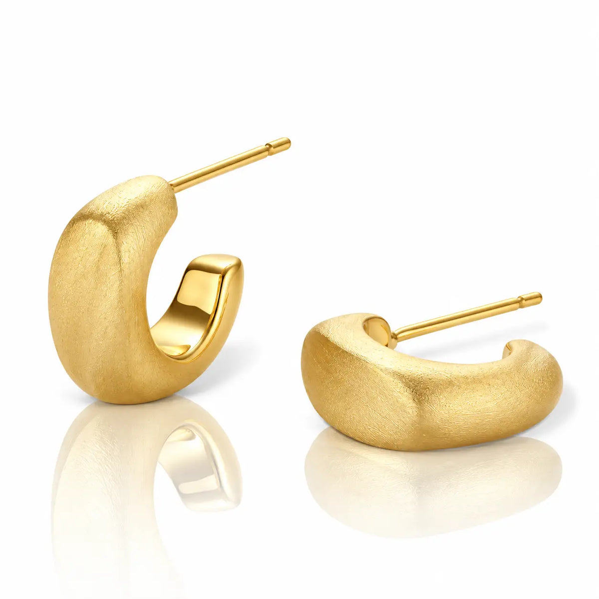 A pair of textured gold huggie hoop earrings with post-back closures, displayed on a clean white background with soft reflections below.